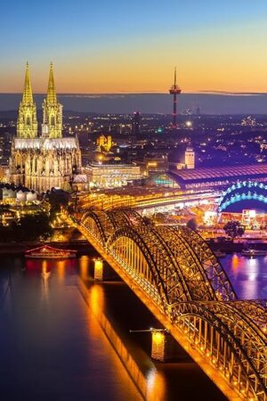 The Ravensburger - Shining Cologne, Germany - 1000 Piece Jigsaw Puzzle - Stunning, Exciting Nighttime Skyline - Bold Colors - Enticing Scene - Ideal Gift - Frameable Art - Puzzles for Adults